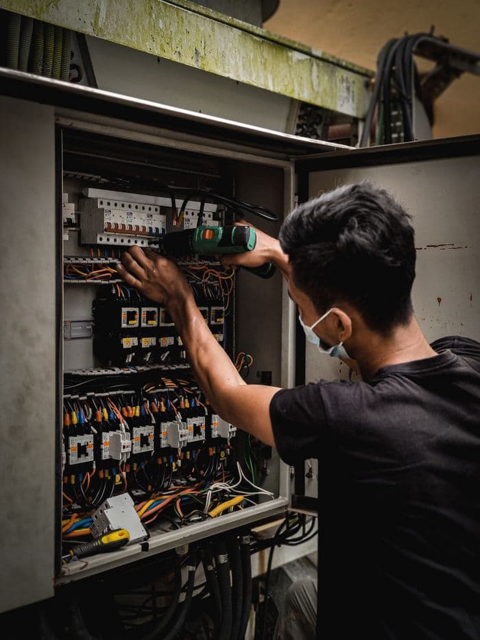 Technician working on an electrical panel
