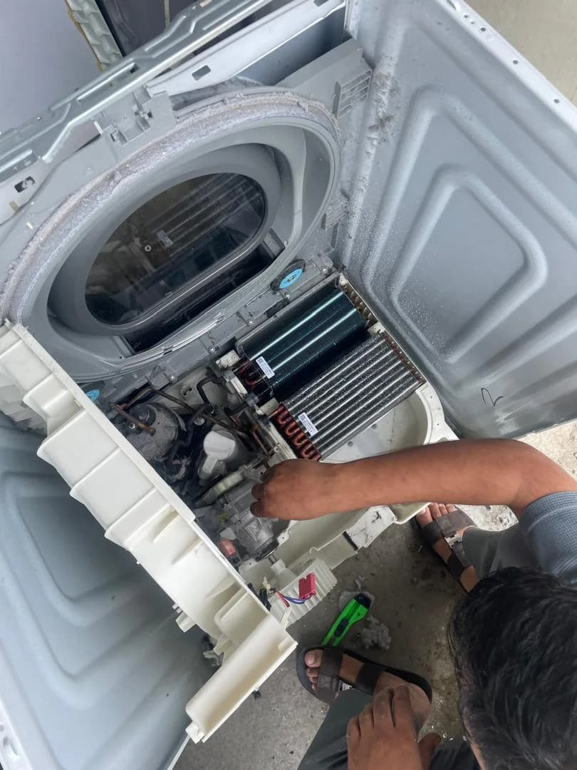 ZiaProTech technician inspecting the internal components of a dryer