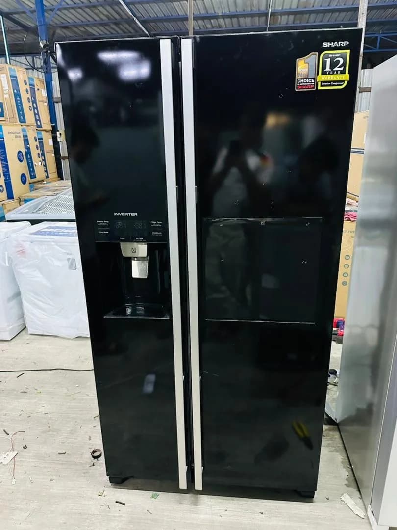 Black side-by-side refrigerator in the repair workshop