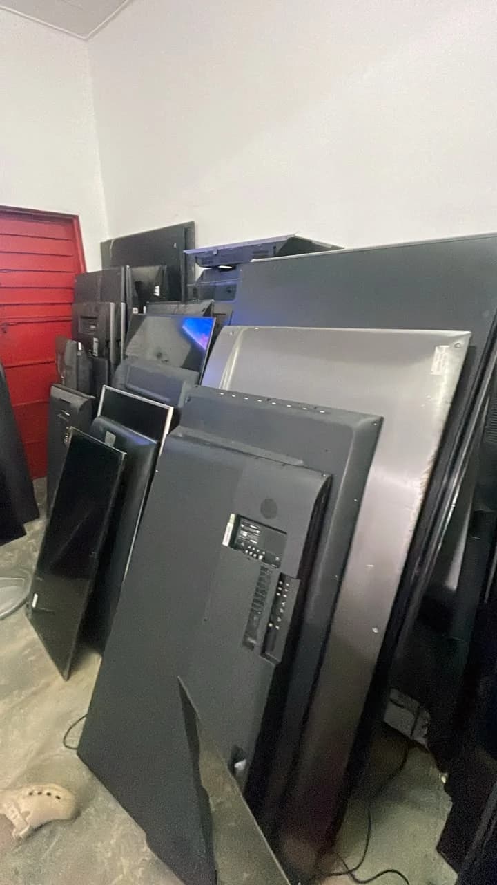 Televisions and back panels arranged inside the repair workshop