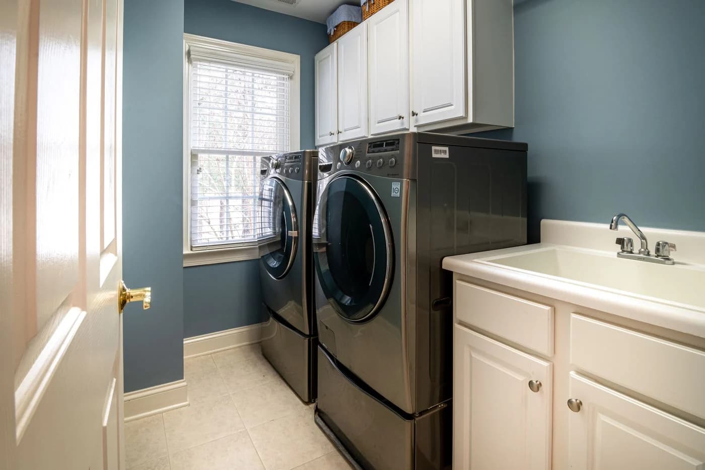 Front-load appliances in a bright home laundry room